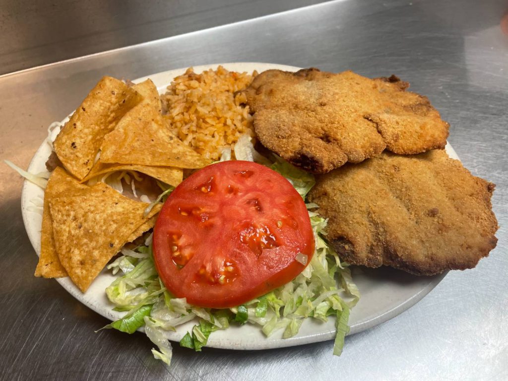 Breaded steak with rice, beans, lettuce and tomato